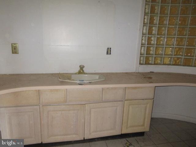 bathroom featuring sink and tile patterned flooring