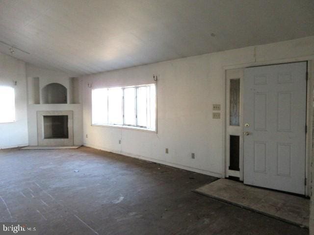 unfurnished living room with vaulted ceiling