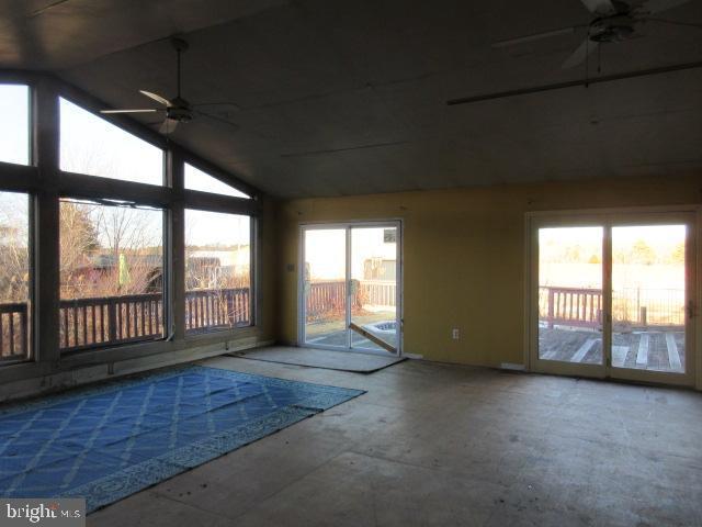 interior space with lofted ceiling and ceiling fan