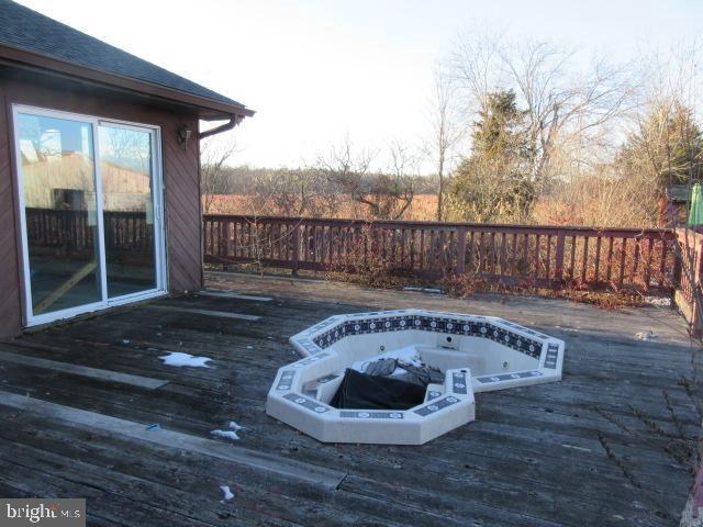 view of pool with a jacuzzi and a wooden deck