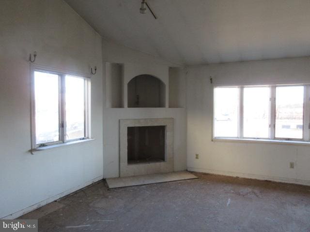 unfurnished living room with lofted ceiling