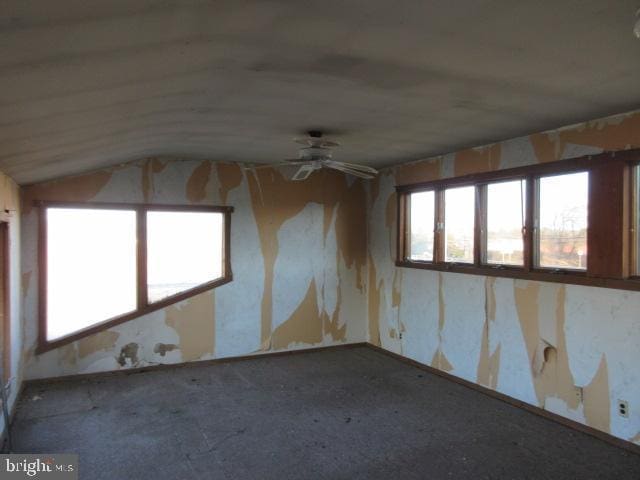 unfurnished room featuring ceiling fan and lofted ceiling