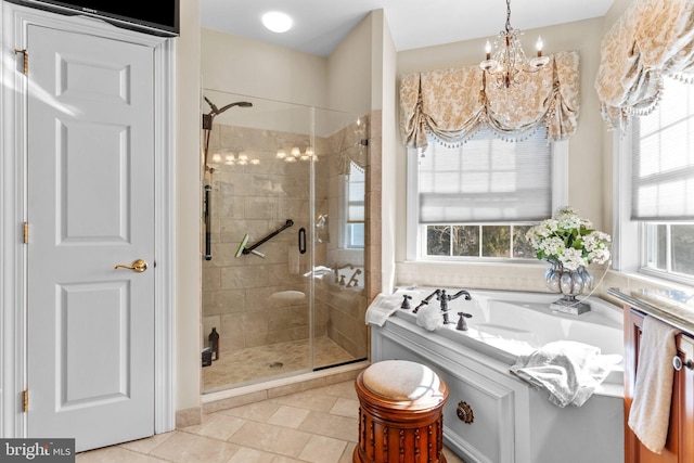 bathroom with an inviting chandelier, plenty of natural light, and a shower with shower door