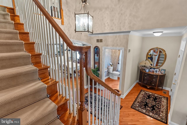 foyer featuring crown molding, a high ceiling, and hardwood / wood-style flooring