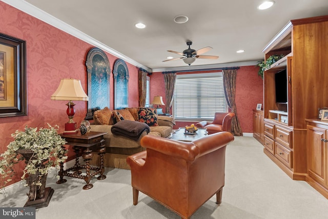 living room featuring ceiling fan, light colored carpet, and ornamental molding