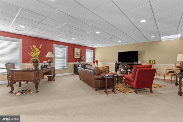 carpeted living room with a paneled ceiling and a healthy amount of sunlight