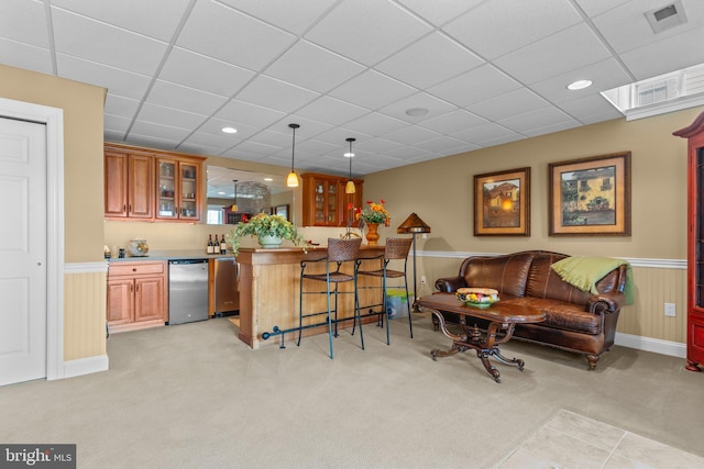 interior space with pendant lighting, a paneled ceiling, light colored carpet, and refrigerator