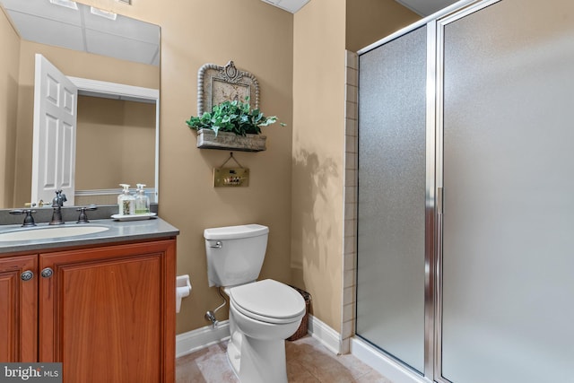 bathroom featuring walk in shower, vanity, toilet, and tile patterned flooring