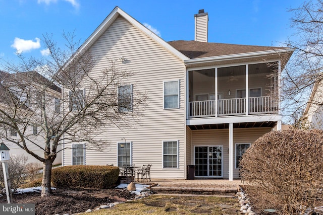 back of house with a patio area and a sunroom