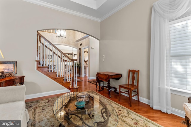 entrance foyer with hardwood / wood-style flooring and crown molding