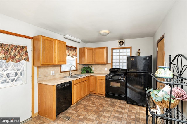 kitchen with sink, backsplash, plenty of natural light, and black appliances