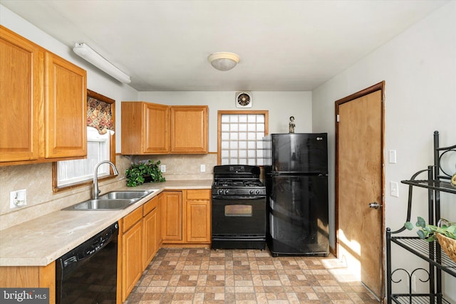 kitchen with sink, decorative backsplash, and black appliances