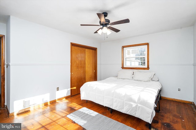 bedroom featuring wood-type flooring, ceiling fan, and a closet