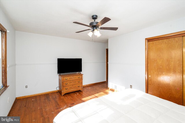 bedroom with ceiling fan and wood-type flooring