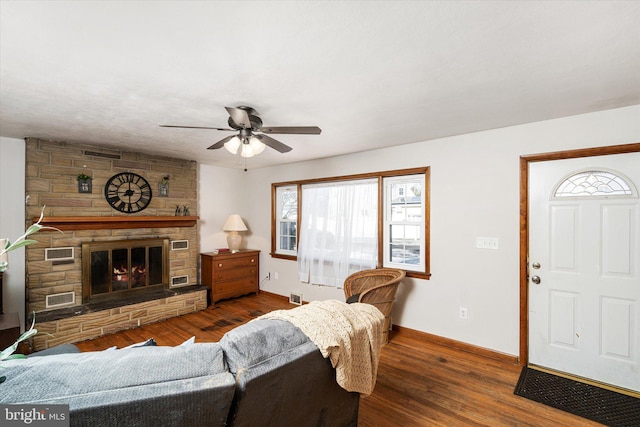 living room with ceiling fan, a fireplace, and dark hardwood / wood-style flooring