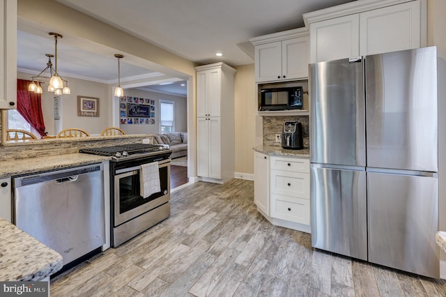 kitchen featuring appliances with stainless steel finishes, light hardwood / wood-style floors, hanging light fixtures, light stone countertops, and white cabinetry