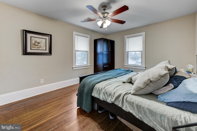 bedroom with ceiling fan and dark wood-type flooring