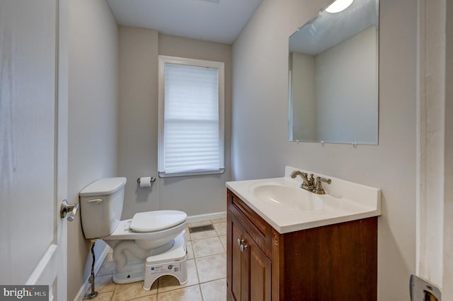 bathroom featuring toilet, vanity, and tile patterned floors