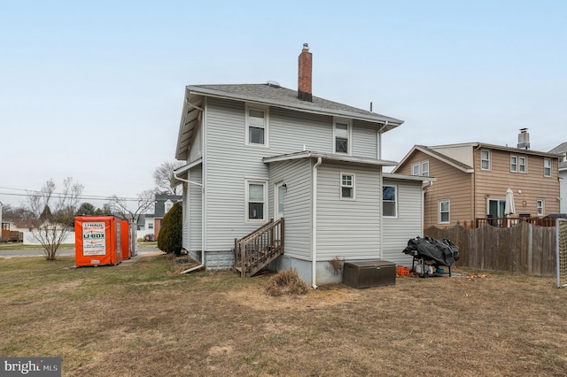 rear view of property with a lawn