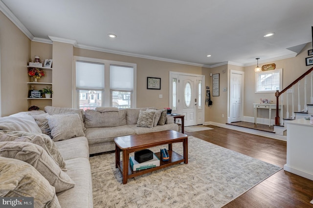 living room featuring ornamental molding, hardwood / wood-style floors, and a wealth of natural light