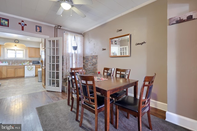 dining area with ornamental molding, a wealth of natural light, and light wood-type flooring