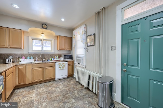 kitchen featuring sink, light brown cabinets, white dishwasher, radiator, and backsplash