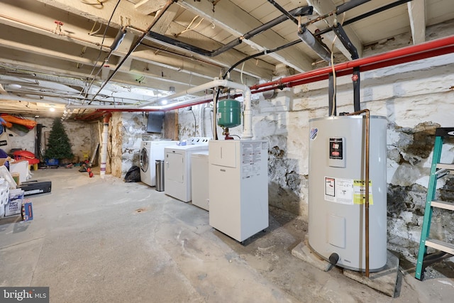 basement featuring washing machine and dryer and water heater