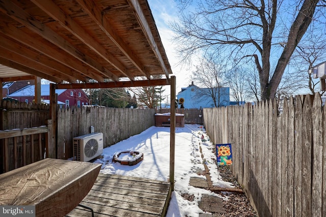 snow covered deck featuring ac unit