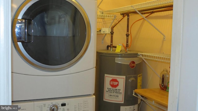 clothes washing area with electric water heater and stacked washing maching and dryer