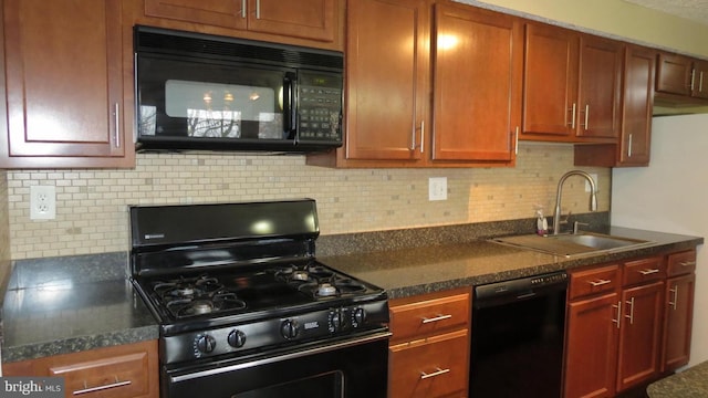 kitchen featuring black appliances, tasteful backsplash, and sink