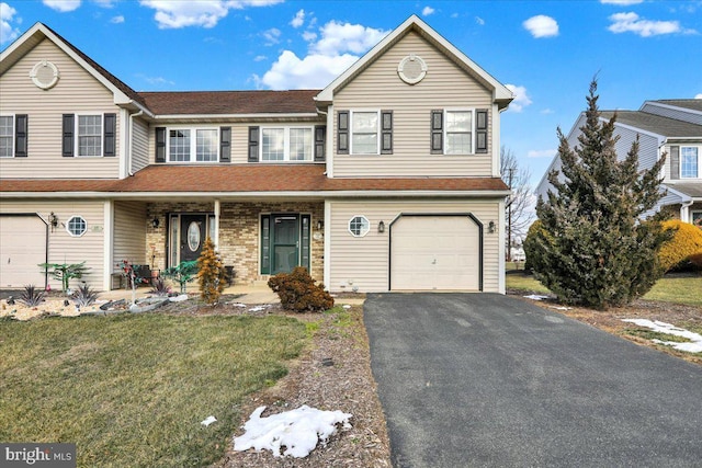 front of property with a garage and a front lawn