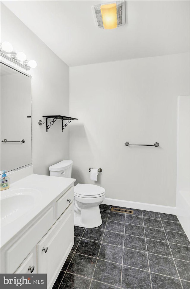 bathroom with toilet, tile patterned flooring, a bath, and vanity