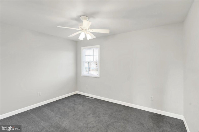 unfurnished room featuring dark carpet and ceiling fan