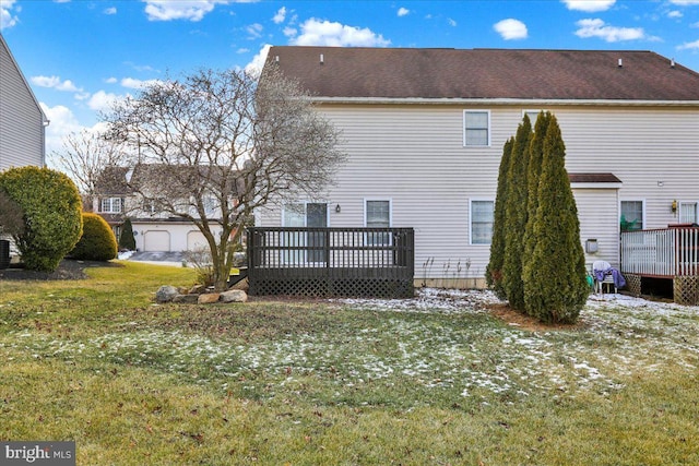 rear view of house featuring a yard and a deck