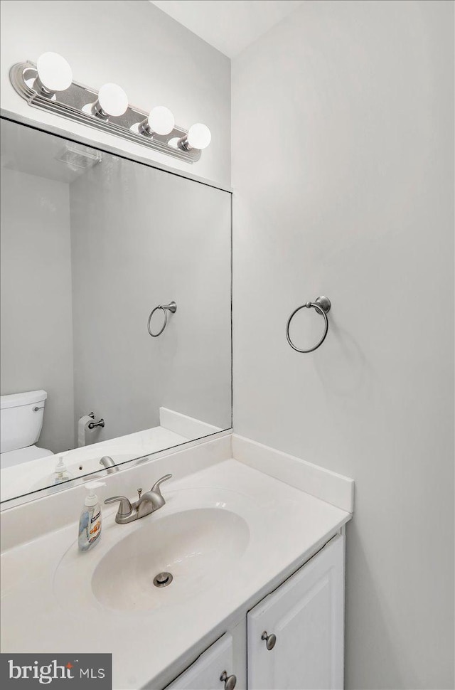 bathroom with toilet and vanity