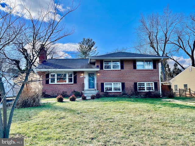 split level home featuring a front lawn