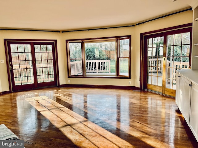 doorway to outside with plenty of natural light and wood-type flooring