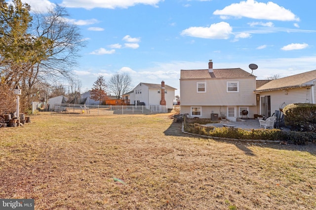 back of property featuring a yard and a patio area