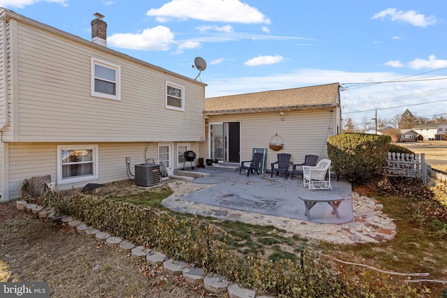 back of property with a patio area and central air condition unit