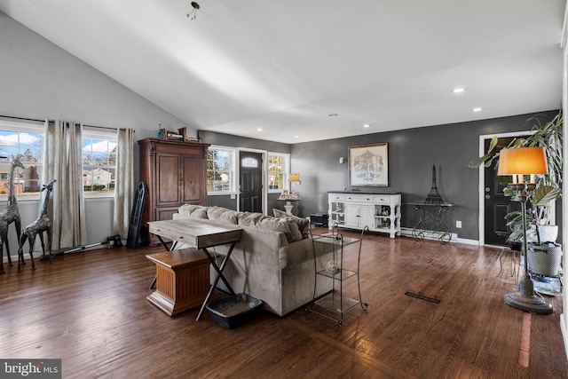 living room with dark hardwood / wood-style flooring and vaulted ceiling