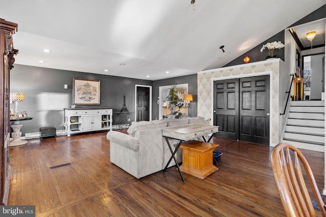 living room featuring vaulted ceiling and dark hardwood / wood-style floors