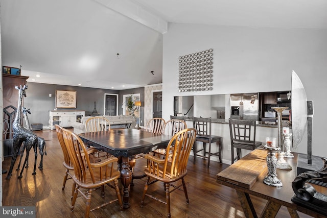 dining area featuring beamed ceiling, dark hardwood / wood-style floors, and high vaulted ceiling