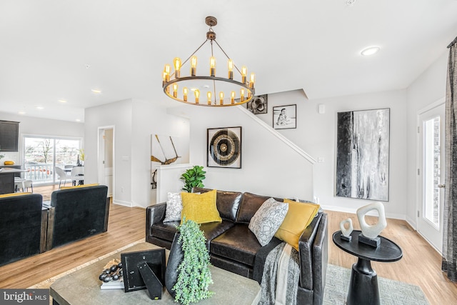 living room featuring a chandelier and light hardwood / wood-style flooring