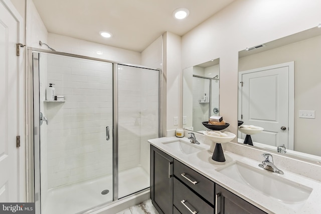 bathroom featuring walk in shower and vanity