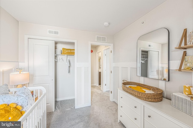 bedroom featuring a closet and light carpet