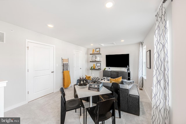 dining area featuring light colored carpet