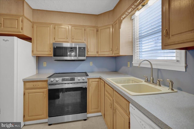 kitchen featuring sink, light brown cabinets, and stainless steel appliances