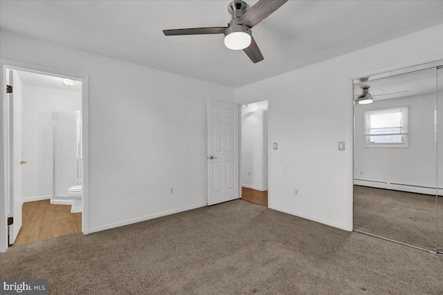 unfurnished bedroom with carpet, a baseboard heating unit, a closet, ceiling fan, and ensuite bathroom