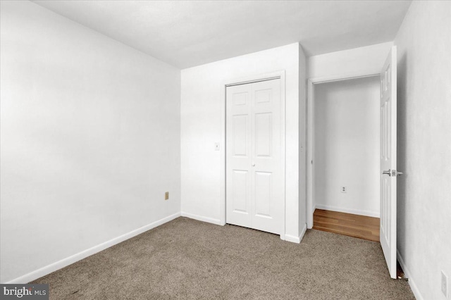 unfurnished bedroom with a closet and carpet