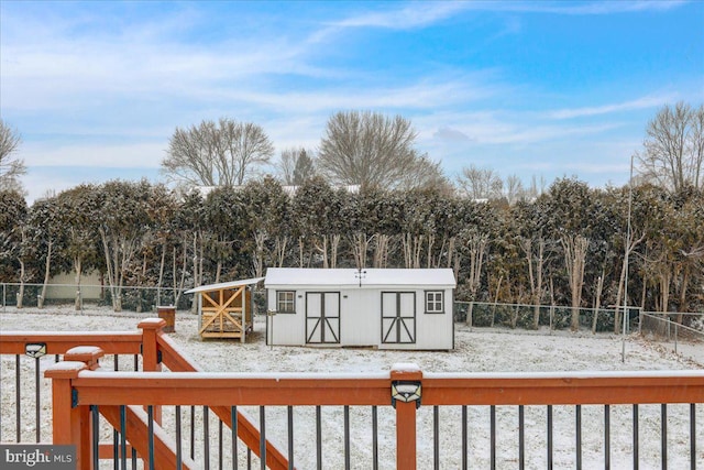 snow covered deck with a storage unit